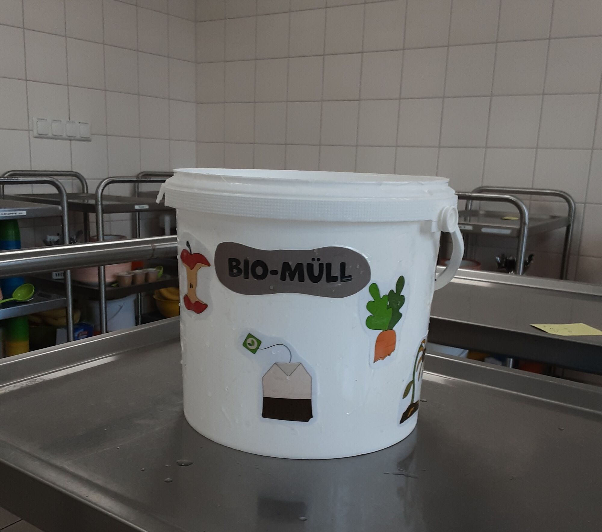 Ein Eimer mit der Aufschrift Bio-M&uuml;ll und aufgeklebten Bildern